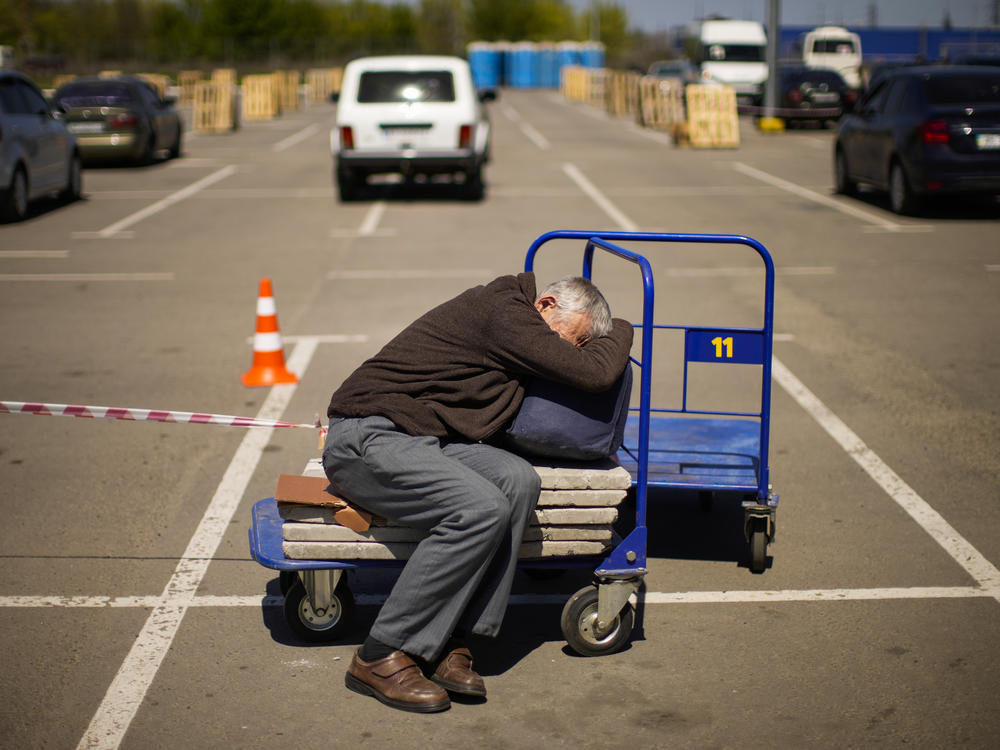 A man who fled from a small village near Polohy rests upon his arrival to a reception center for displaced people in Zaporizhzhia, Ukraine, on Sunday.