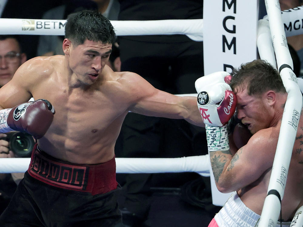 Dmitry Bivol, left, throws a left at Canelo Álvarez in the fifth round of their WBA light heavyweight title fight in Las Vegas.