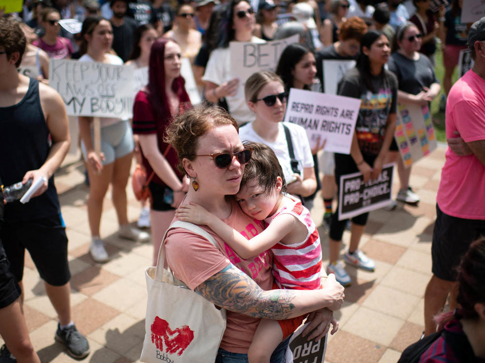 An attendee holds her child during A Texas Rally for Abortion Rights at Discovery Green in Houston, Texas, on May 7. Recently passed laws make abortion illegal after about six weeks into a pregnancy.