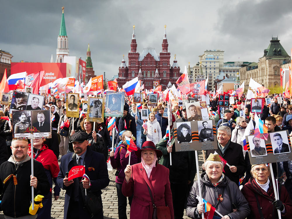 People carry portraits of their relatives, including World War II soldiers, as they take part in the Immortal Regiment march on Red Square on Monday in Moscow. The event is part of Russia's Victory Day, celebrating the Soviet Union's defeat of Nazi Germany, which took on new importance with the invasion of Ukraine.