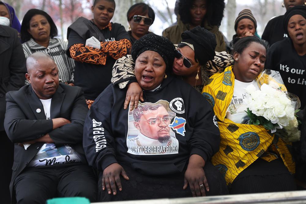 Dorcas Lyoya (center), the mother of Patrick Lyoya, is comforted as she grieves the loss of her son while he is laid to rest at Resurrection Cemetery on April 22 in Wyoming, Michigan. Patrick Lyoya, a 26-year-old immigrant from the Democratic Republic of the Congo, died after being shot in the back of the head by a Grand Rapids police officer following a traffic stop on April 4.