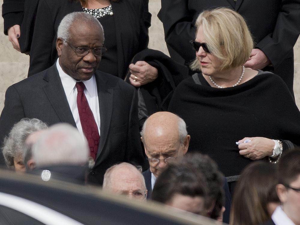 Supreme Court Associate Justice Clarence Thomas, left and his wife Virginia Thomas, right, leave the the Basilica of the National Shrine of the Immaculate Conception in Washington after attending funeral services of the late Supreme Court Associate Justice Antonin Scalia, on Feb. 20, 2016.
