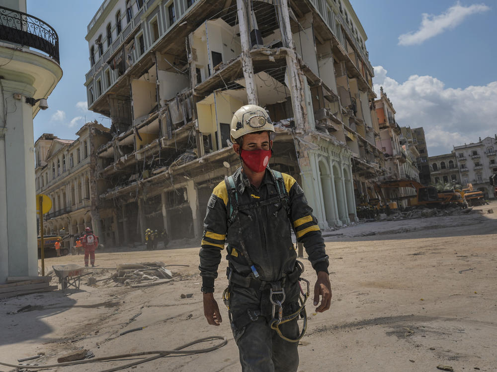 A rescue worker walks away from the destroyed five-star Hotel Saratoga on Tuesday after searching through the rubble days after a deadly explosion in Old Havana, Cuba.