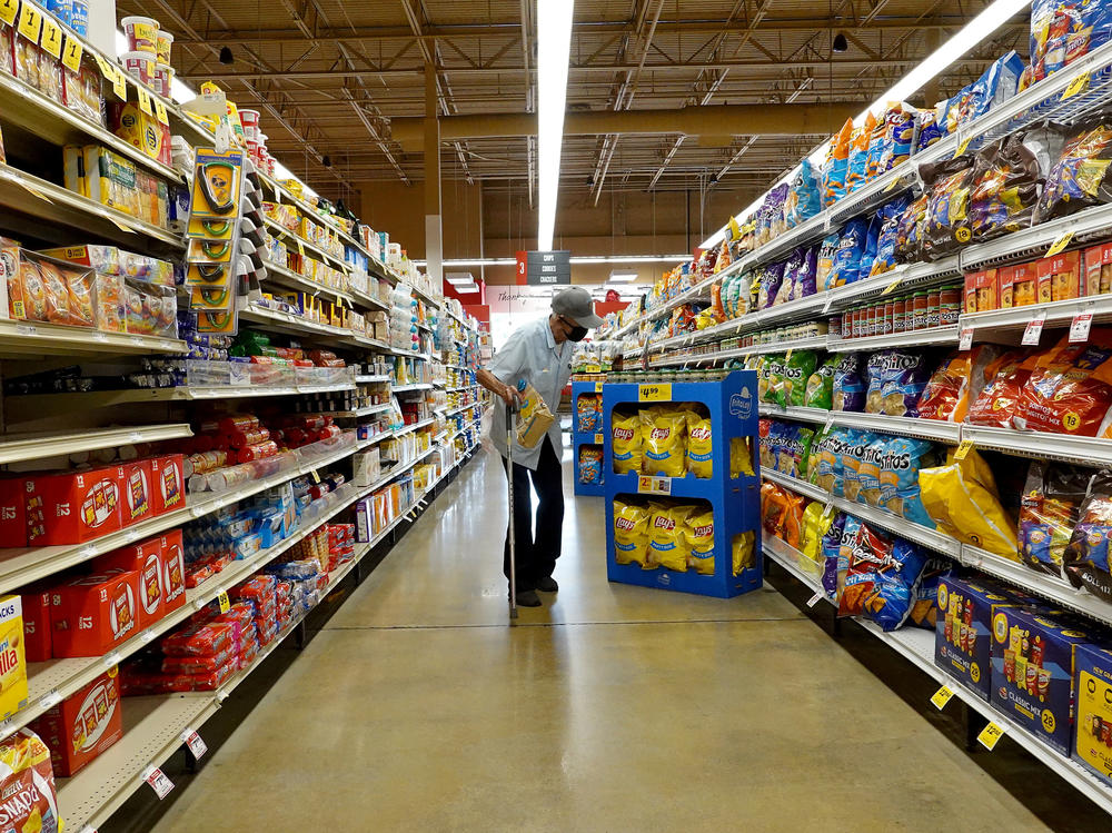 Tackling inflation remains a top priority for the Federal Reserve and the Biden administration. Here, a customer shops at a grocery store in Miami on Feb. 10.