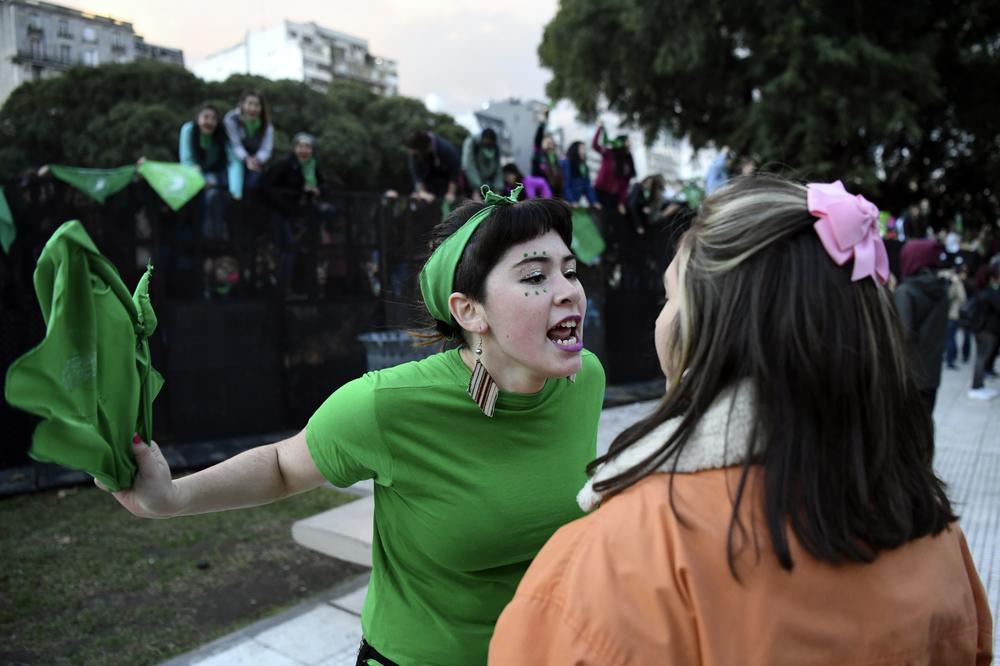 A pro-choice activist (in green) argues with a woman opposed to the legalization of abortion outside the Argentine Congress in Buenos Aires on June 13, 2018 — the year that Argentina legalized abortion.