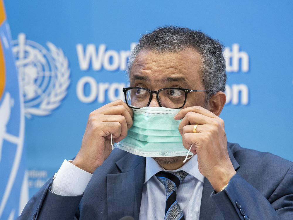 Tedros Adhanom Ghebreyesus, director general of the World Health Organization, removes his protective face mask prior to speaking to the media at the WHO headquarters in Geneva, Switzerland, on Dec. 20, 2021.