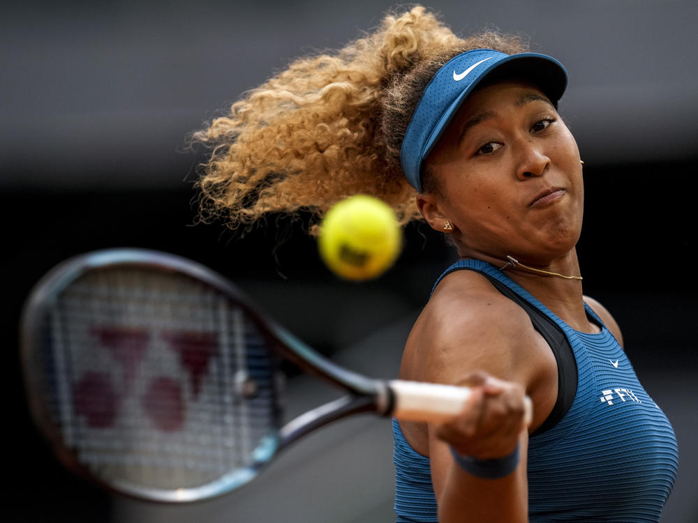 Naomi Osaka of Japan returns the ball against Sara Sorribes Tormo of Spain during their match at the Mutua Madrid Open tennis tournament in Madrid, Spain, on May 1, 2022.