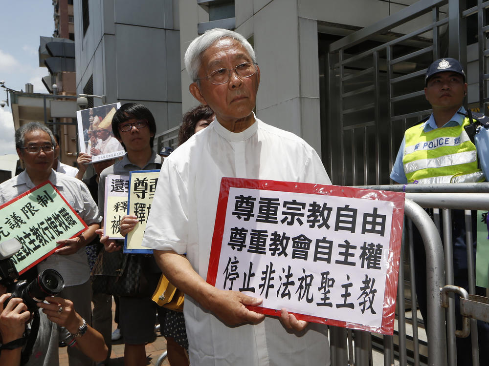 Hong Kong's outspoken cardinal Joseph Zen, center, and other religious protesters hold placards with 