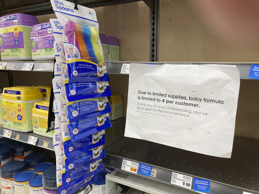 A sign telling consumers of limits on the purchase of baby formula hangs on the edge of an empty shelf for the product in a King Soopers grocery store, Wednesday, in Denver.