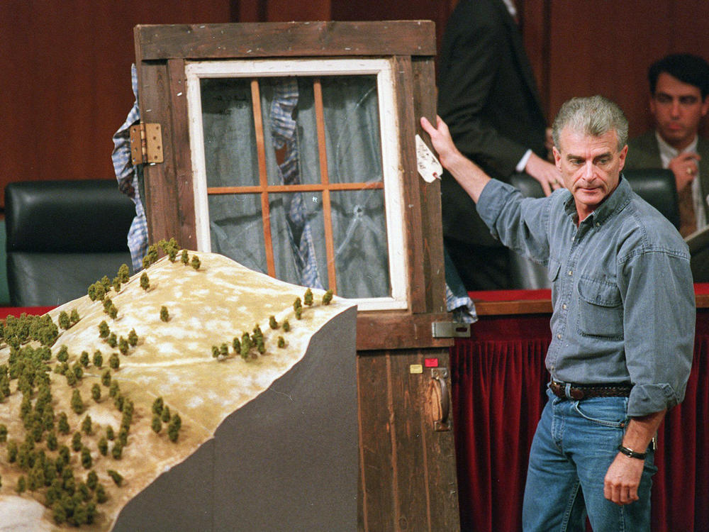 Randy Weaver holds the door of his cabin showing holes from bullets fired during the 1992 siege of his Ruby Ridge, Idaho home during testimony before the Senate Judiciary Subcommittee on Capitol Hill in Washington on Sept. 6, 1995.