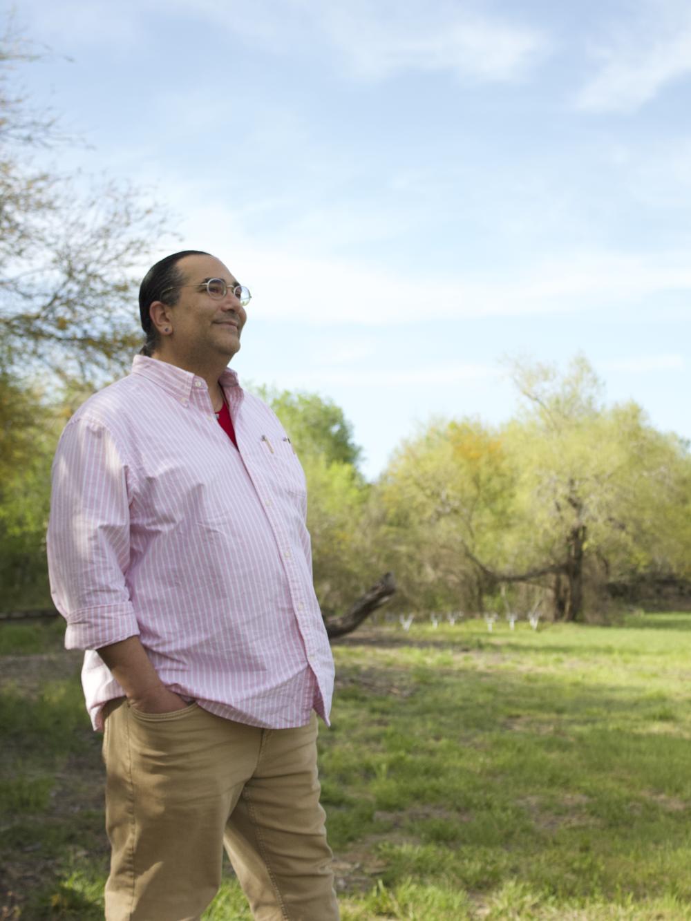 Christopher Basaldú, PhD, stands at Resaca De Las Palmas State Park in Brownsville. Basaldú was forced to find new housing when rents started raising across the city.