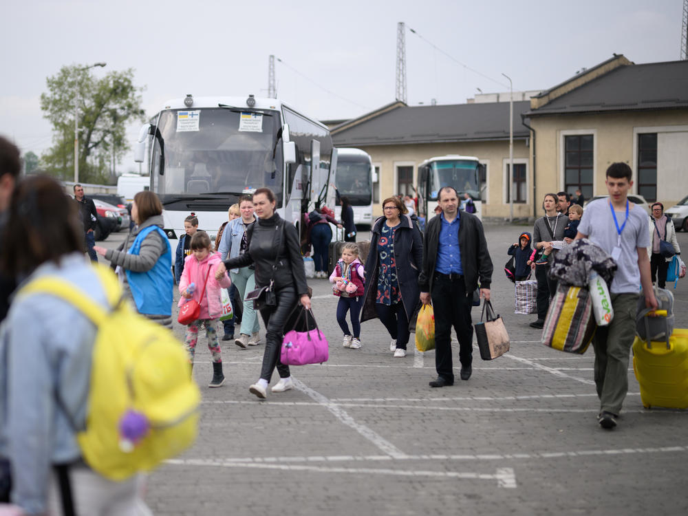 Refugees from war-torn regions of Ukraine board a coach to Warsaw at a coach station on Saturday in Lviv, Ukraine. A U.N. agency estimates that nearly 5 million jobs have been lost in Ukraine since Russia first invaded in late February.