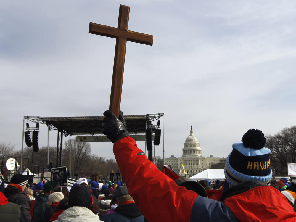 A man holds a cross during an anti-abortion rally on the National Mall in Washington on Jan. 24, 2011.