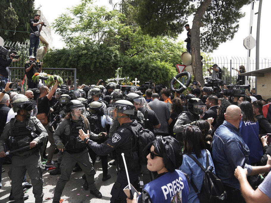 Israeli police in riot gear confront mourners and the journalists on Friday covering the transfer from the hospital of slain Al Jazeera veteran journalist Shireen Abu Akleh to her final resting place in east Jerusalem. Abu Akleh, a Palestinian-American reporter, was shot dead Wednesday during an Israeli military raid in the West Bank town of Jenin.
