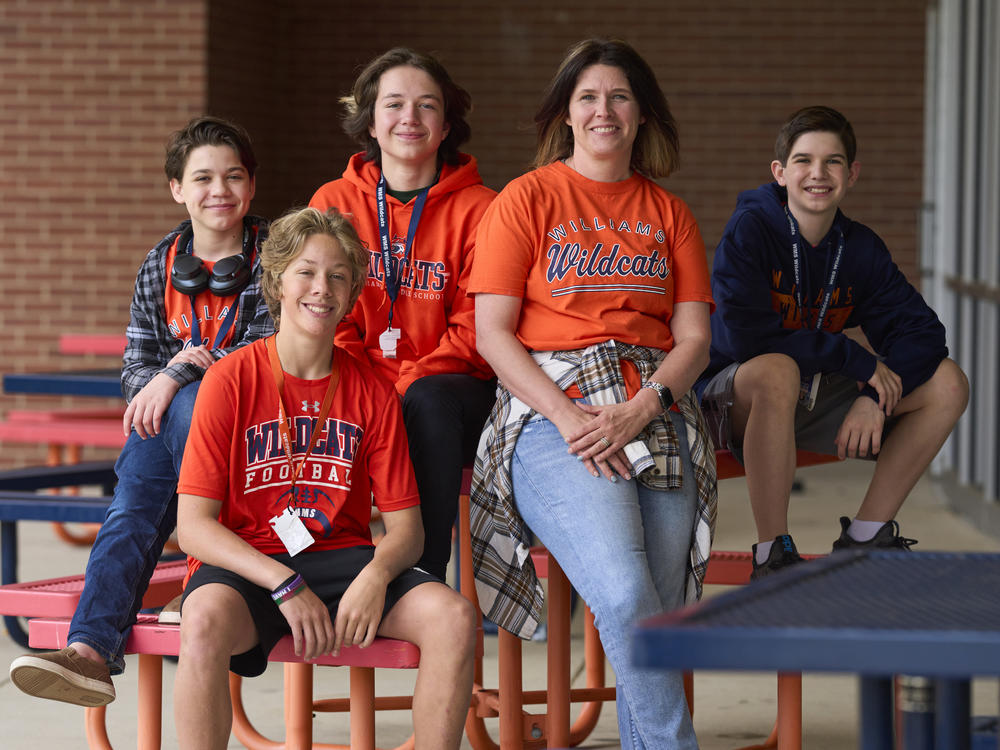 Middle school winners Harrison McDonald, Wesley Helmer, Kit Atteberry, and Blake Turkey pose with librarian Misti Knight.