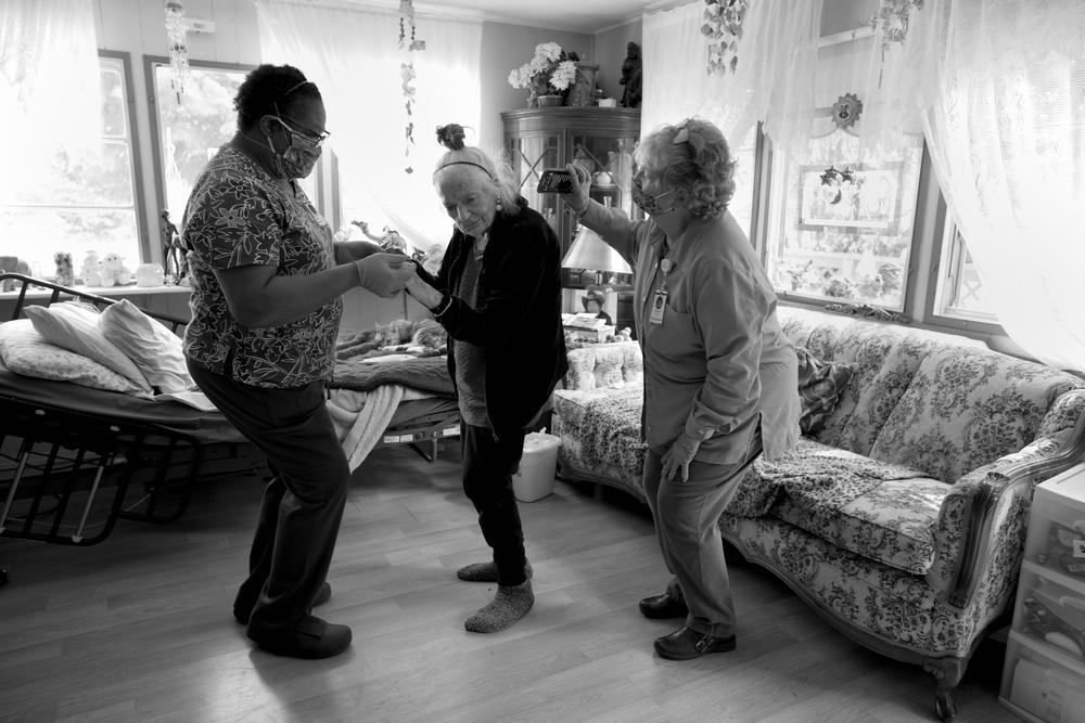 Chaplain Charlotte Keys holds an iPhone and blasts Gudrun Johnston's favorite dance music, while Jetton takes her for a twirl to celebrate her birthday on April 23, 2020. Taking off their personal protective equipment for the party is an uncommon exception to their typical routine.