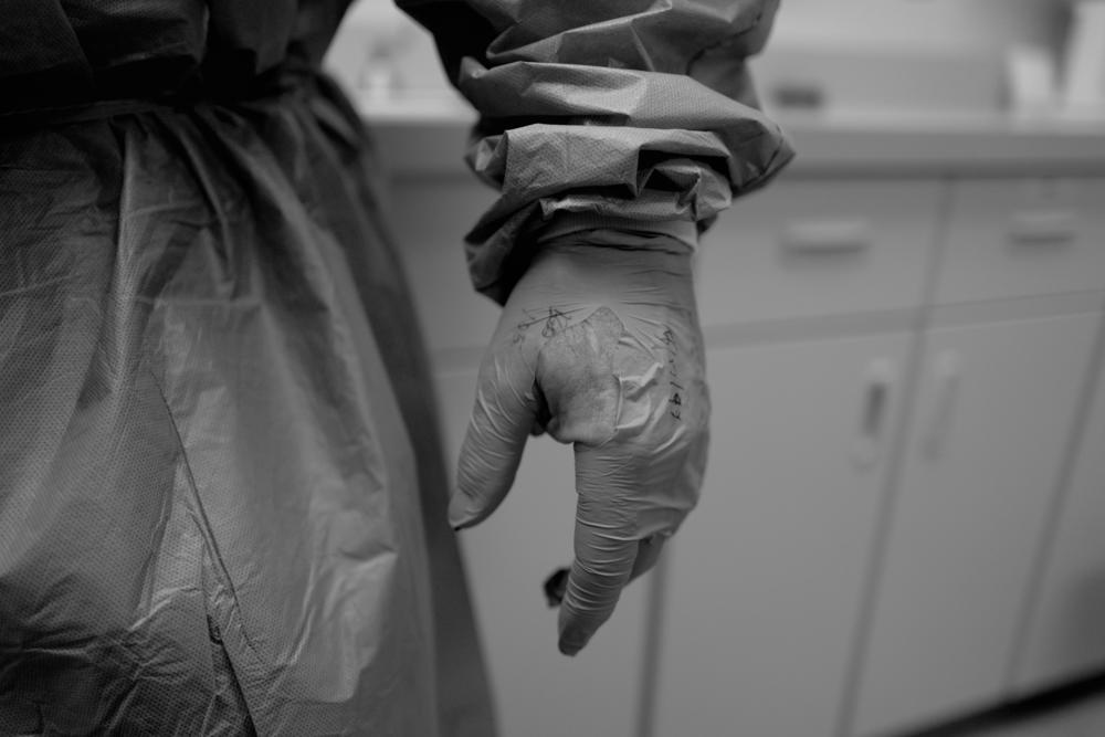 Neal's glove was shredded after a rough ride in the ambulance spent trying to control a young woman they picked up outside of her friend's apartment in May of 2020.