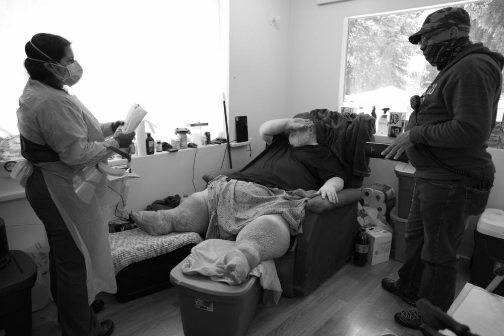 Sierra (left) and Richard West (right) meet with a patient at home on June 1, 2020. West is a mental health outreach counselor for Island County, which includes Whidbey and Camano islands. West's parents died from COVID-19 in 2020.