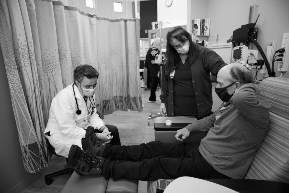 Oncology nurse Lisa Toomey and Dr. Amir Mehrvarz try to determine the cause of the serious pain that patient Alcide Levac is experiencing on Nov. 6, 2020. Many cancer patients delayed their treatments in fear of COVID, exacerbating disease markers and symptoms.