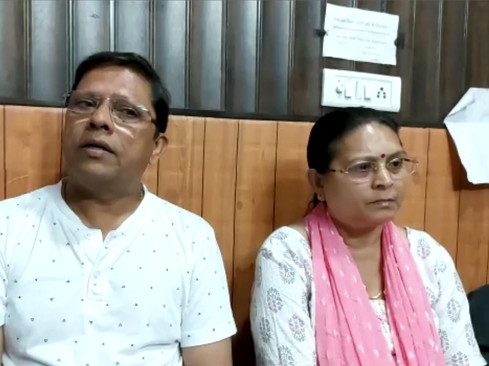 This image from video shows Sanjeev Ranjan Prasad, a 61-year-old retired government officer, and his wife Sadhana Prasad as they wait at a lawyer's chamber in Haridwar, India, on Thursday. The couple has sued their son and daughter-in-law, demanding a grandchild within a year or compensation of 50 million rupees ($675,675).