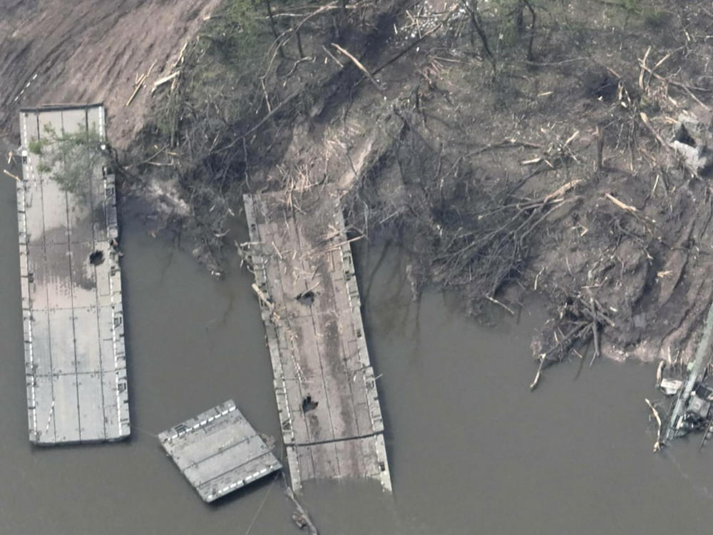 This handout photo provided by the Ukraine Armed Forces on Thursday is said to show a ruined pontoon crossing with dozens of destroyed or damaged Russian armored vehicles on both banks of the Siverskyi Donets River after their pontoon bridges were blown up in eastern Ukraine.