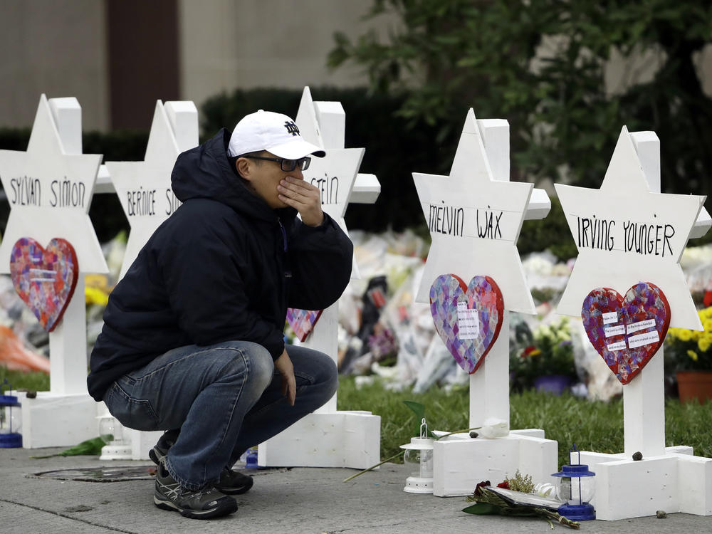 A person pauses in front of Stars of David with the names of those killed in a deadly shooting at the Tree of Life synagogue in Pittsburgh in October 2018.