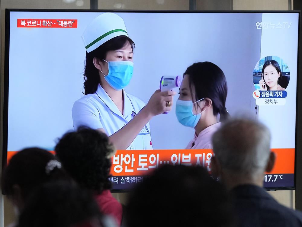 People watch a TV screen showing a news report about the COVID-19 outbreak in North Korea, at a train station in Seoul, South Korea, Saturday, May 14, 2022. North Korea on Saturday reported 21 new deaths and 174,440 more people with fever symptoms as the country scrambles to slow the spread of COVID-19 across its unvaccinated population.