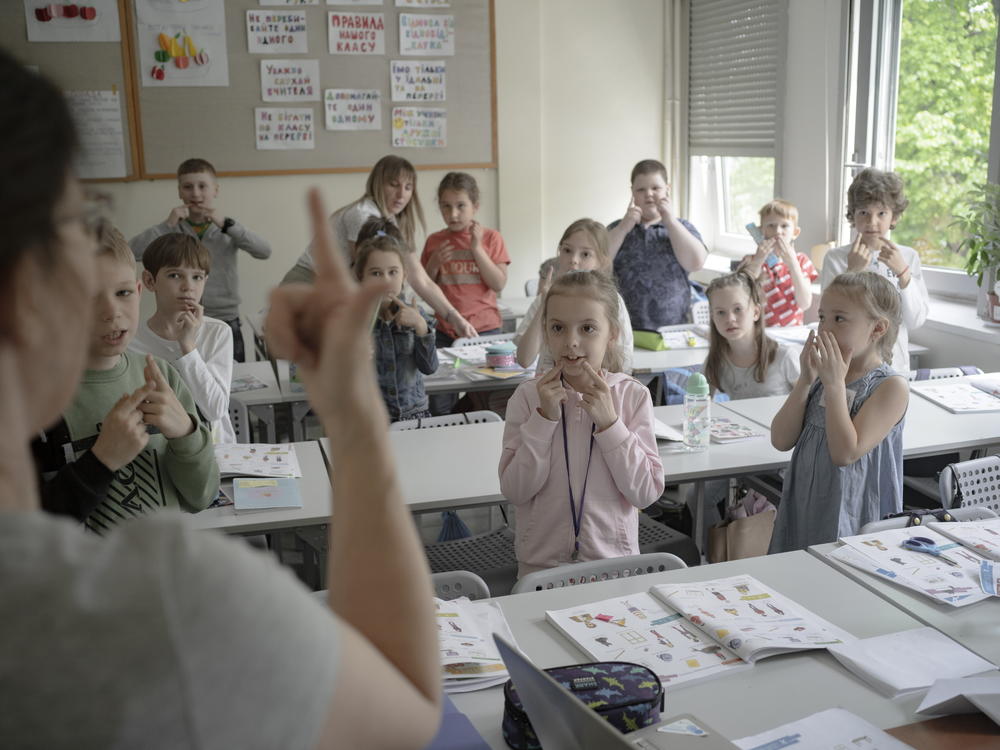 Students interact with a teacher during a lesson at Poland's Warsaw Ukrainian School, on Wednesday, May 11, 2022.