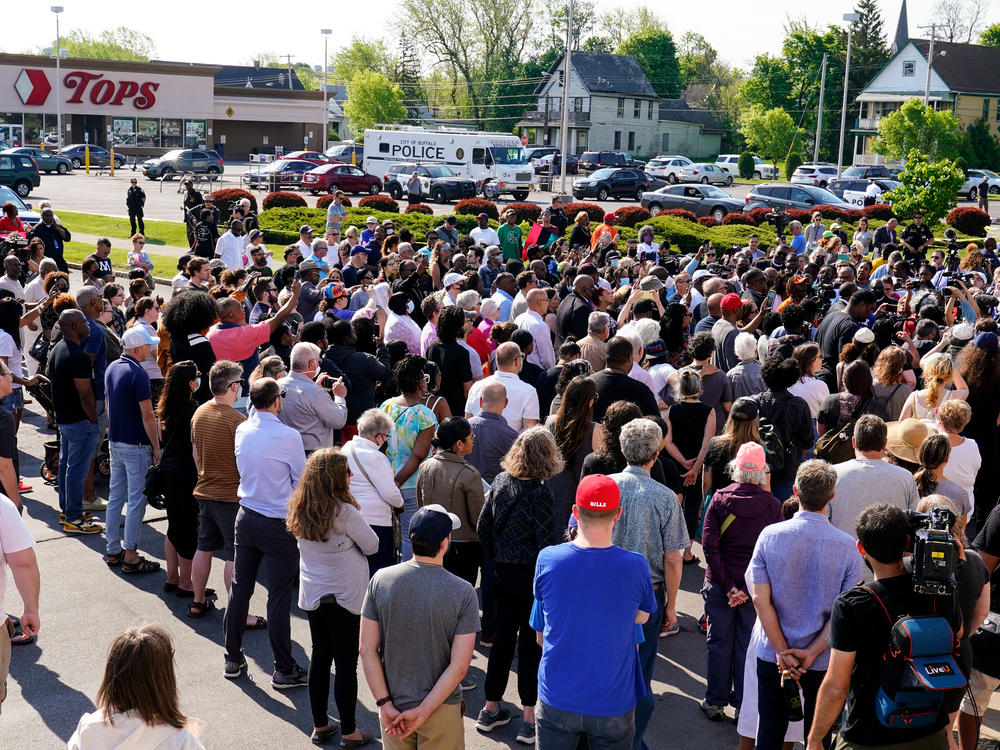 People gather outside the scene of a shooting at a supermarket in Buffalo, N.Y., Sunday, May 15, 2022.