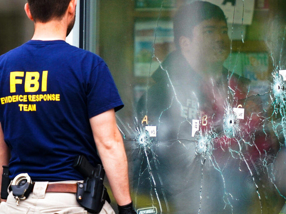Investigators work the scene of a shooting at a supermarket, in Buffalo, N.Y., on Monday.