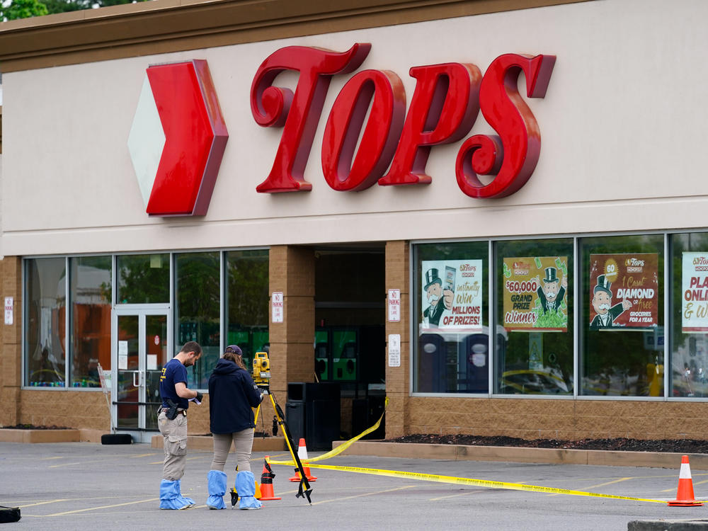 Investigators work the scene of a shooting at a supermarket in Buffalo, N.Y. on Monday.