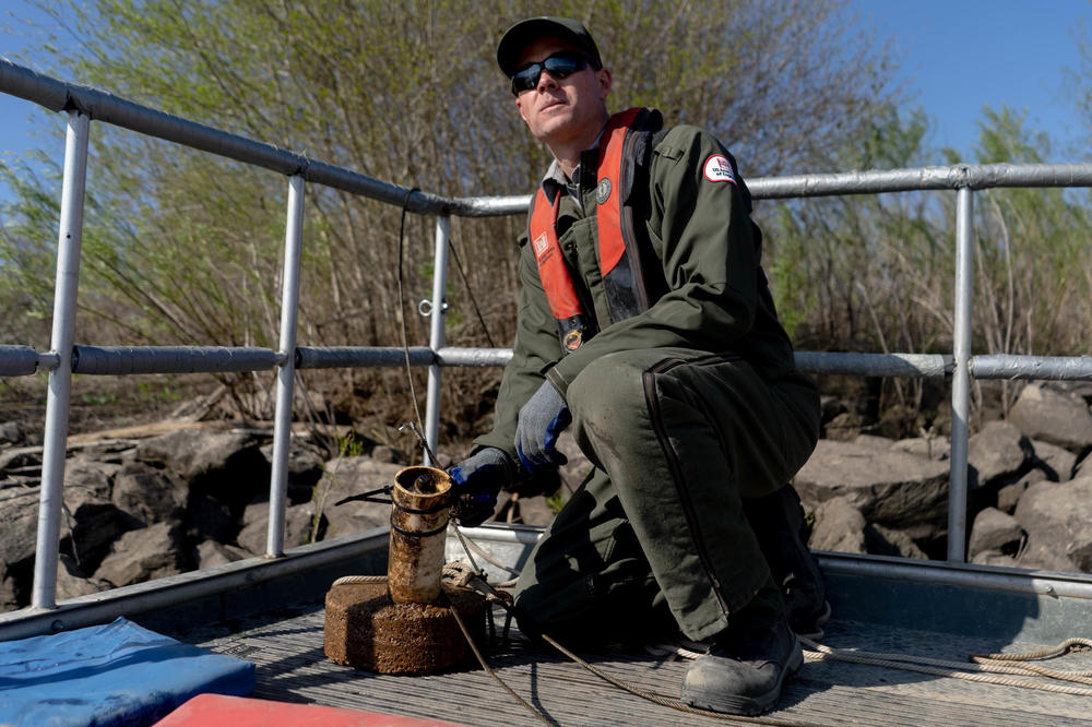 Ryan Swearingin, a wildlife biologist with the U.S. Army Corps of Engineers, holds a fish-tracking receiver.