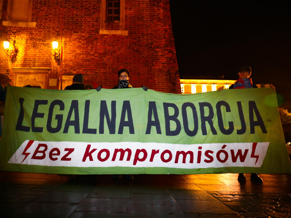 Demonstrators in Krakow, Poland, hold a banner reading 