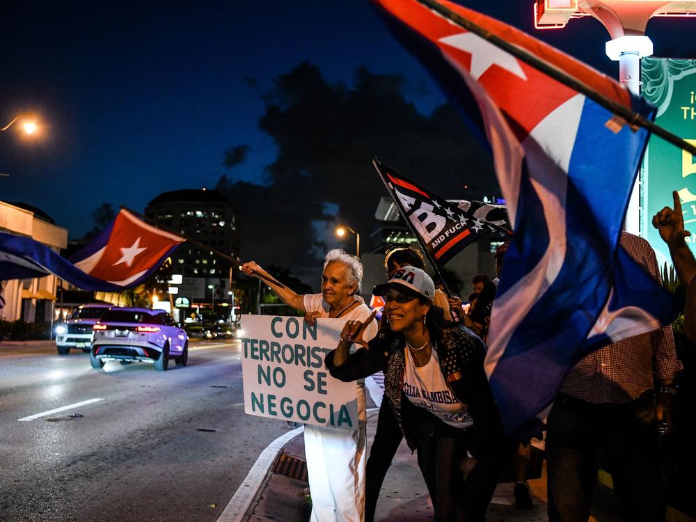 Holding a sign reading 