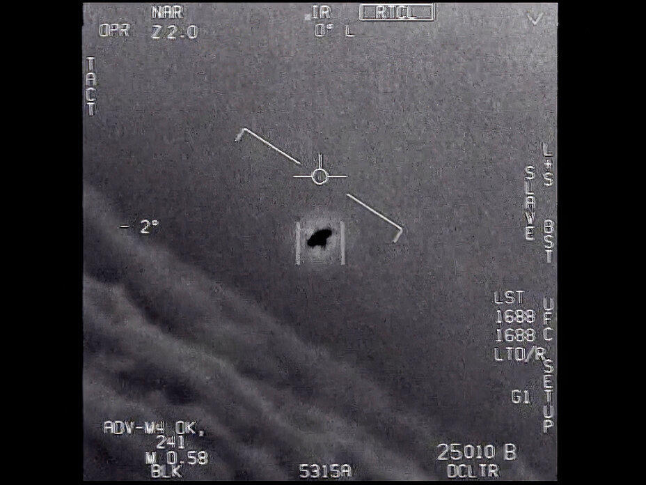 In this image from 2015 video provided by the Department of Defense, an unexplained object is seen as it is tracked soaring high along the clouds, traveling against the wind.