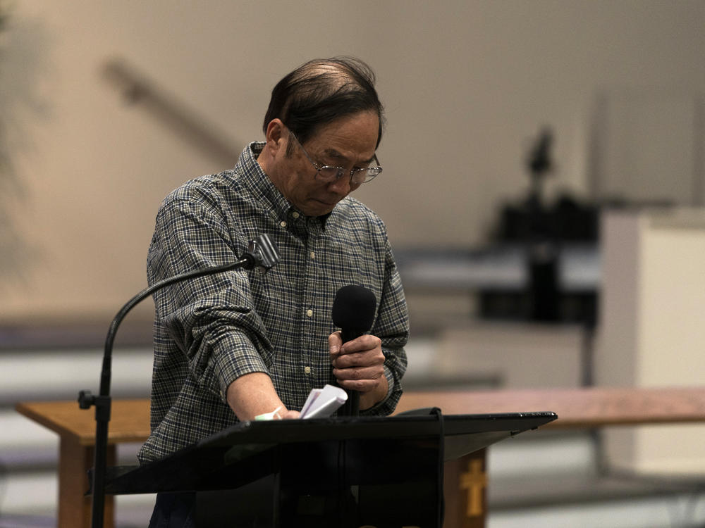 Billy Chang, a Taiwanese pastor who survived Sunday's shooting at Geneva Presbyterian Church, gets emotional while speaking at a prayer vigil in Irvine, Calif., on Monday.