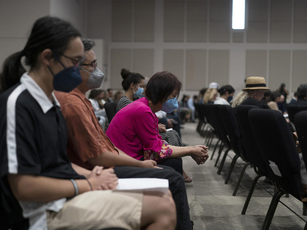 People pray during a prayer vigil in Irvine, Calif., Monday, May 16, 2022. The vigil was held to honor victims in Sunday's shooting at Geneva Presbyterian Church in Laguna Woods, Calif.