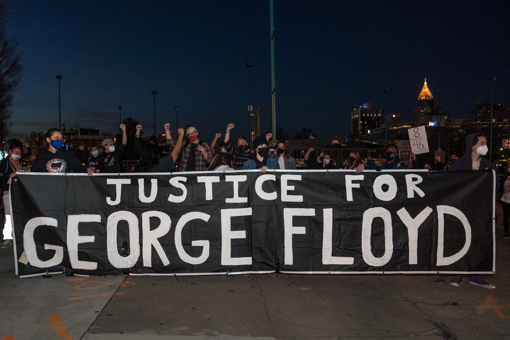 Demonstrators hold a vigil in honor of George Floyd on March 8, 2021 in Atlanta, Ga.
