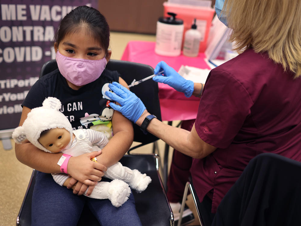 First grader Rihanna Chihuaque, 7, receives a COVID-19 vaccine at Arturo Velasquez Institute in Chicago last November.