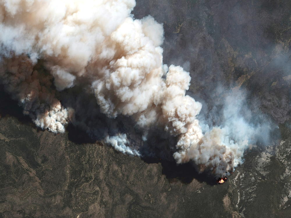 A satellite image shows a natural color view of active fire lines from the Hermits Peak and Calf Canyon fires, near Las Vegas, New Mexico, on May 11.