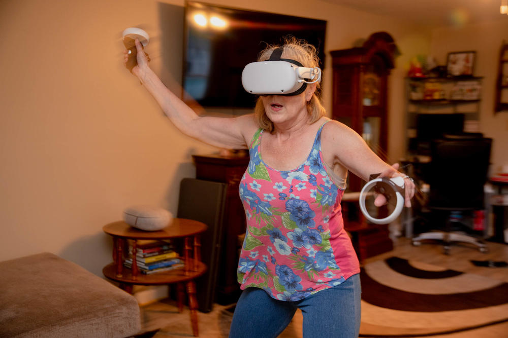 Linda Munson, 56, exercises wearing the Oculus Quest in her living room. 