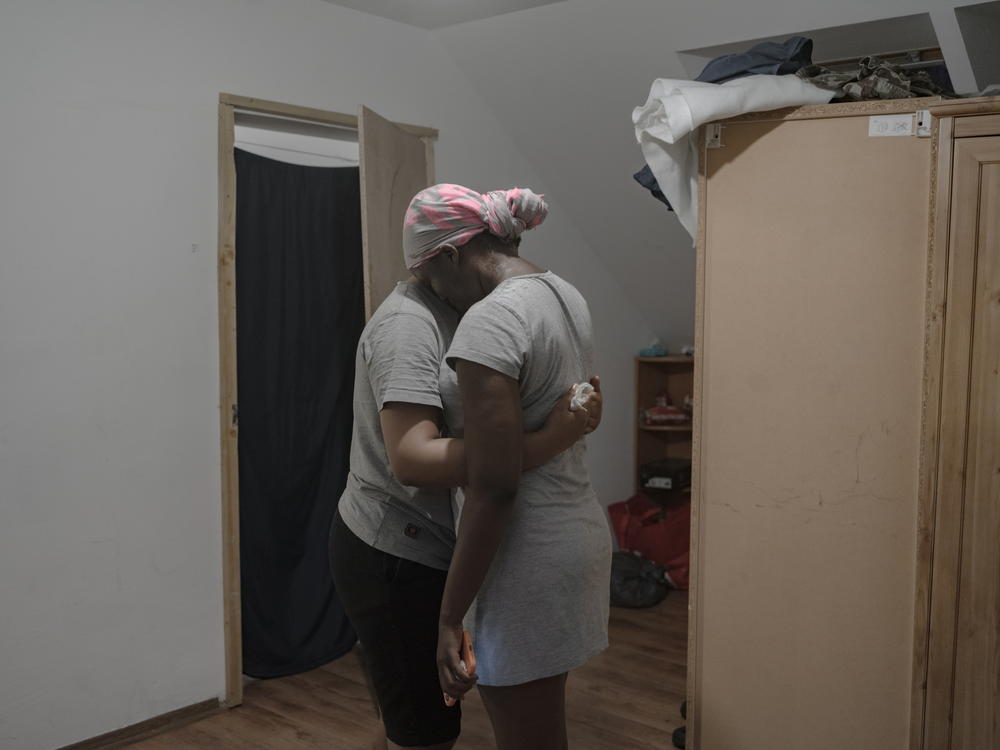 Ima hugs Shakira at a shelter provided by the Nigerians Diaspora Organization in Poland.