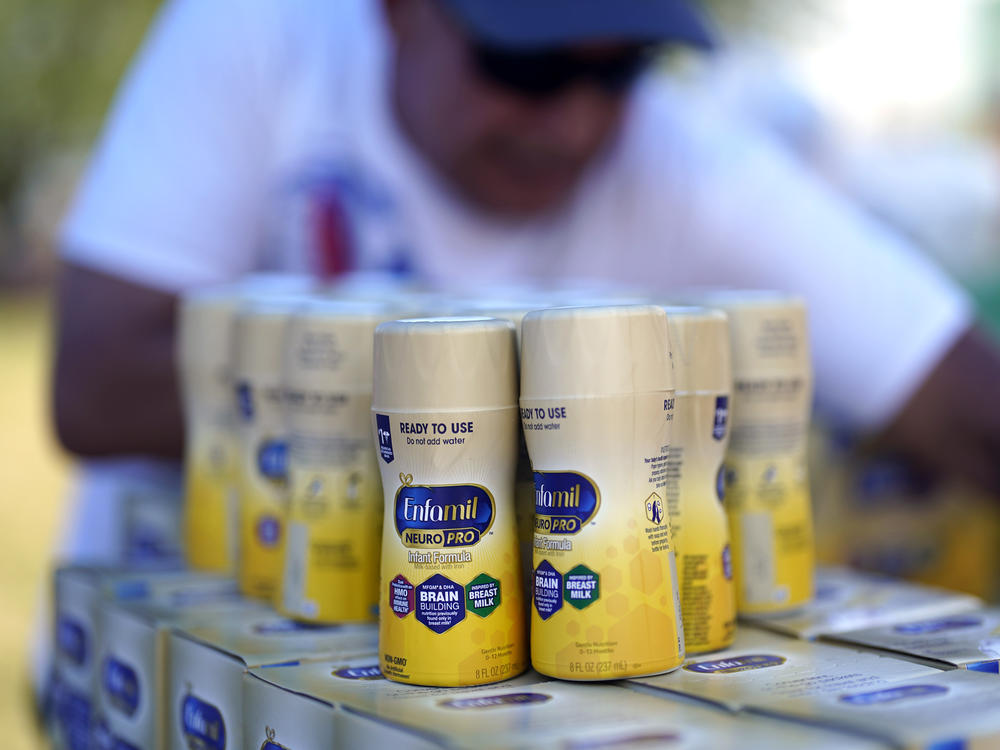 Infant formula is stacked on a table during a baby formula drive to help with the shortage on Saturday in Houston.
