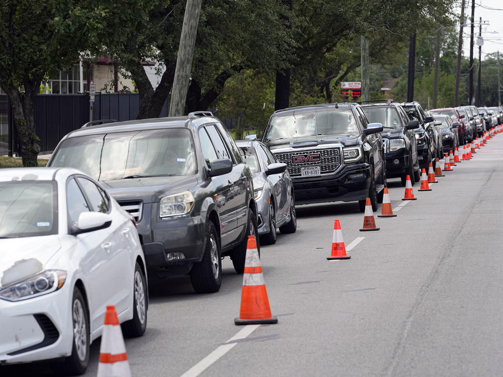 People wait in line during a baby formula drive to help with the baby formula shortage on Saturday in Houston.