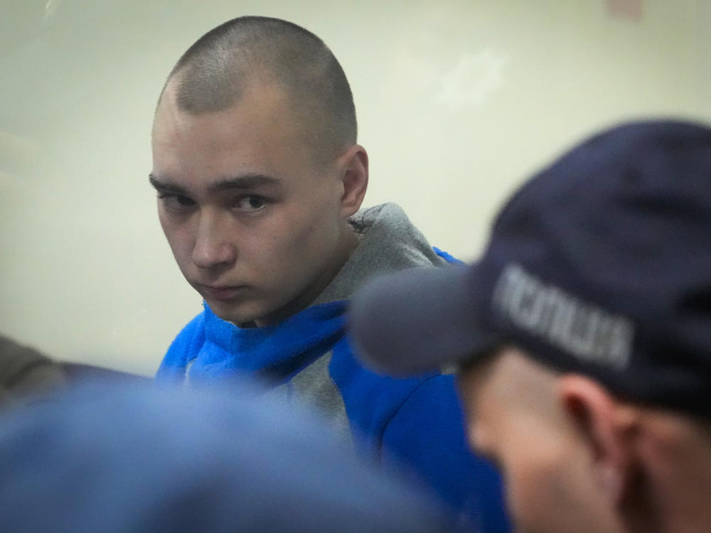Russian army Sgt. Vadim Shishimarin, 21, is seen behind glass during a court hearing in Kyiv, Ukraine, on Wednesday. Shishimarin pleaded guilty to killing an unarmed Ukrainian civilian.
