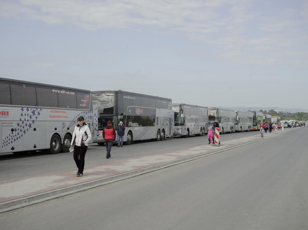 Buses line up to take Ukrainians back over the border and home.