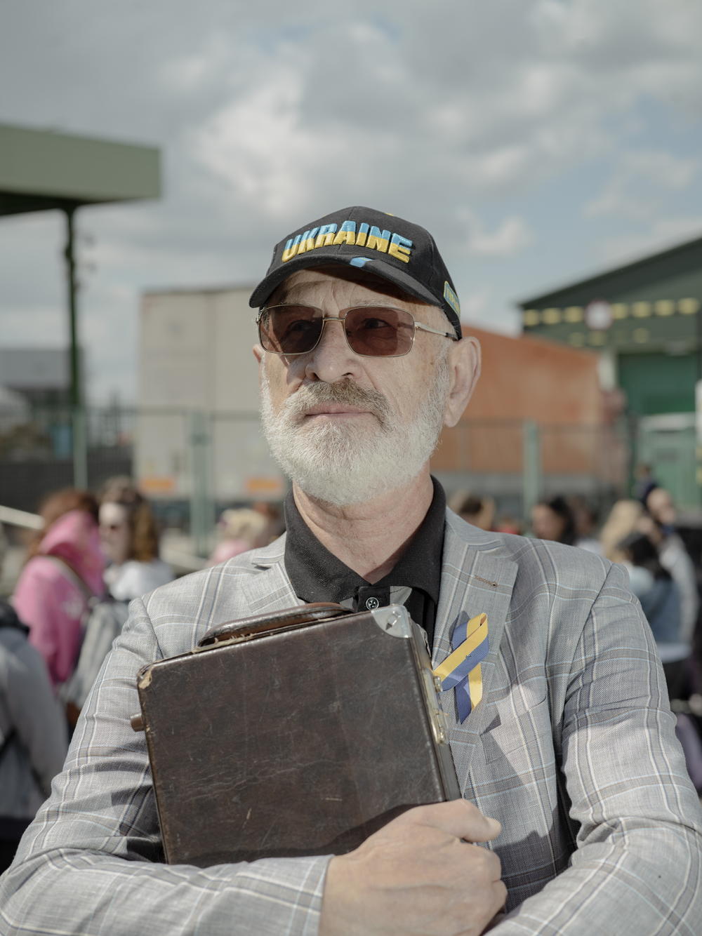Yuri Vasylevych, 71, waits with his saxophone at the Poland-Ukraine border to cross to the Ukrainian side.