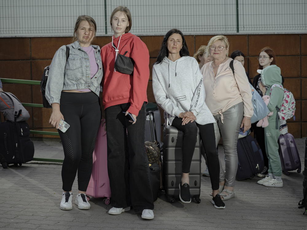 Snizhana Khomenko, Veronica Naboka, Violetta Naboka and their friend wait to cross the border.
