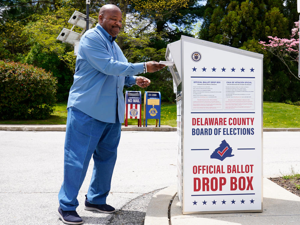 A voter drops off his mail ballot for the 2022 Pennsylvania primary elections in Newtown Square, Pa., on May 2. The state's Supreme Court has ruled in a lawsuit challenging the constitutionality of a state law that expanded mail-in voting.