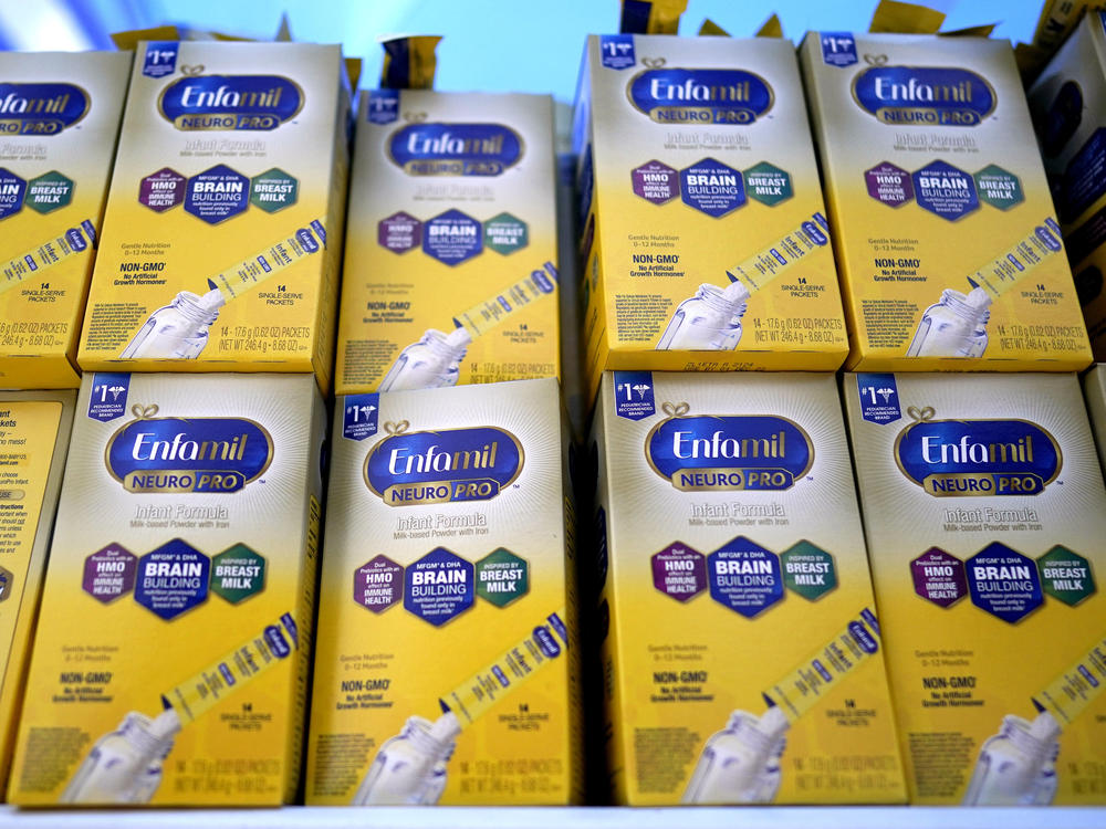 Infant formula made by a subsidiary of Reckitt is stacked on a table during a baby formula drive to help with the shortage on Saturday in Houston. The FDA announced a preliminary agreement with Abbott, a competitor, to restart production at a Michigan factory.